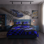 A racing-themed bedding set displayed on a bed in a styled bedroom. The set includes a comforter and two matching pillowcases featuring a blue and black checkered pattern with a blue race car graphic and 'Racing Life' text.