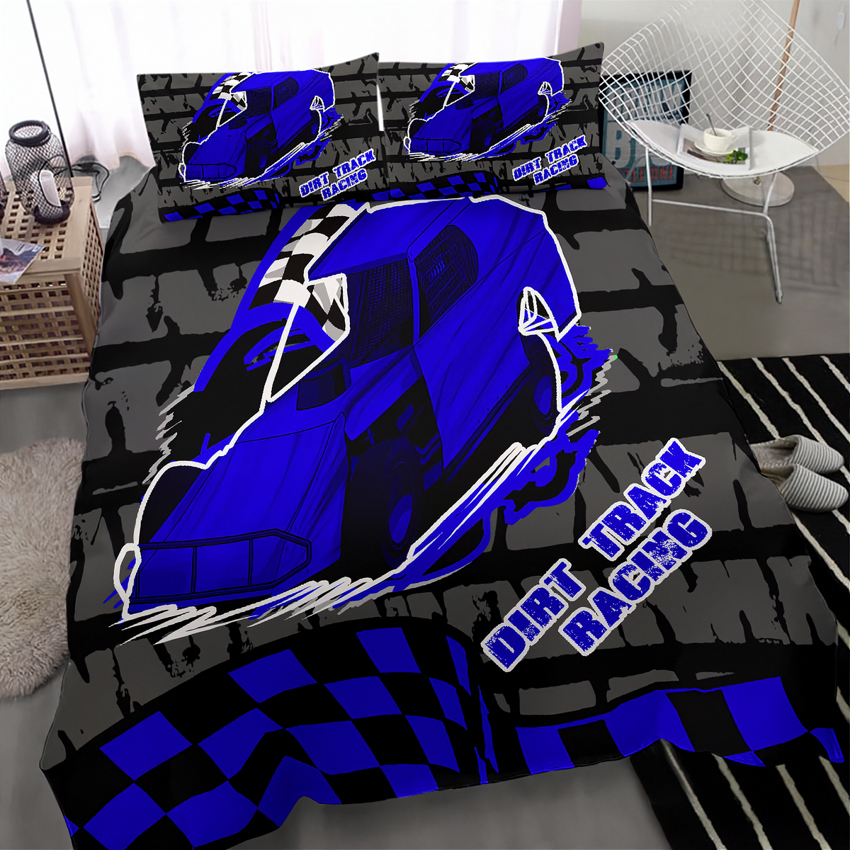 A bedding set featuring a bold blue and black dirt track racing design, including a large car graphic, checkered flag pattern, and 'DIRT TRACK RACING' text, shown on a bed in a modern bedroom setting.