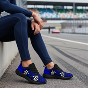 Person sitting on a race track wearing blue checkered shoes
