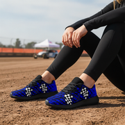 Woman sitting at a dirt track wearing a Dirt Racing Blue Muddy Flag Sneakers 