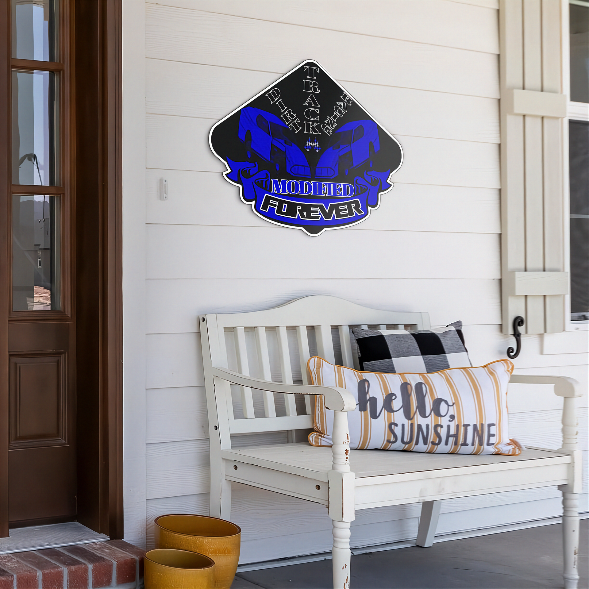 A decorative metal sign reading 'dirt track racing modified forever.