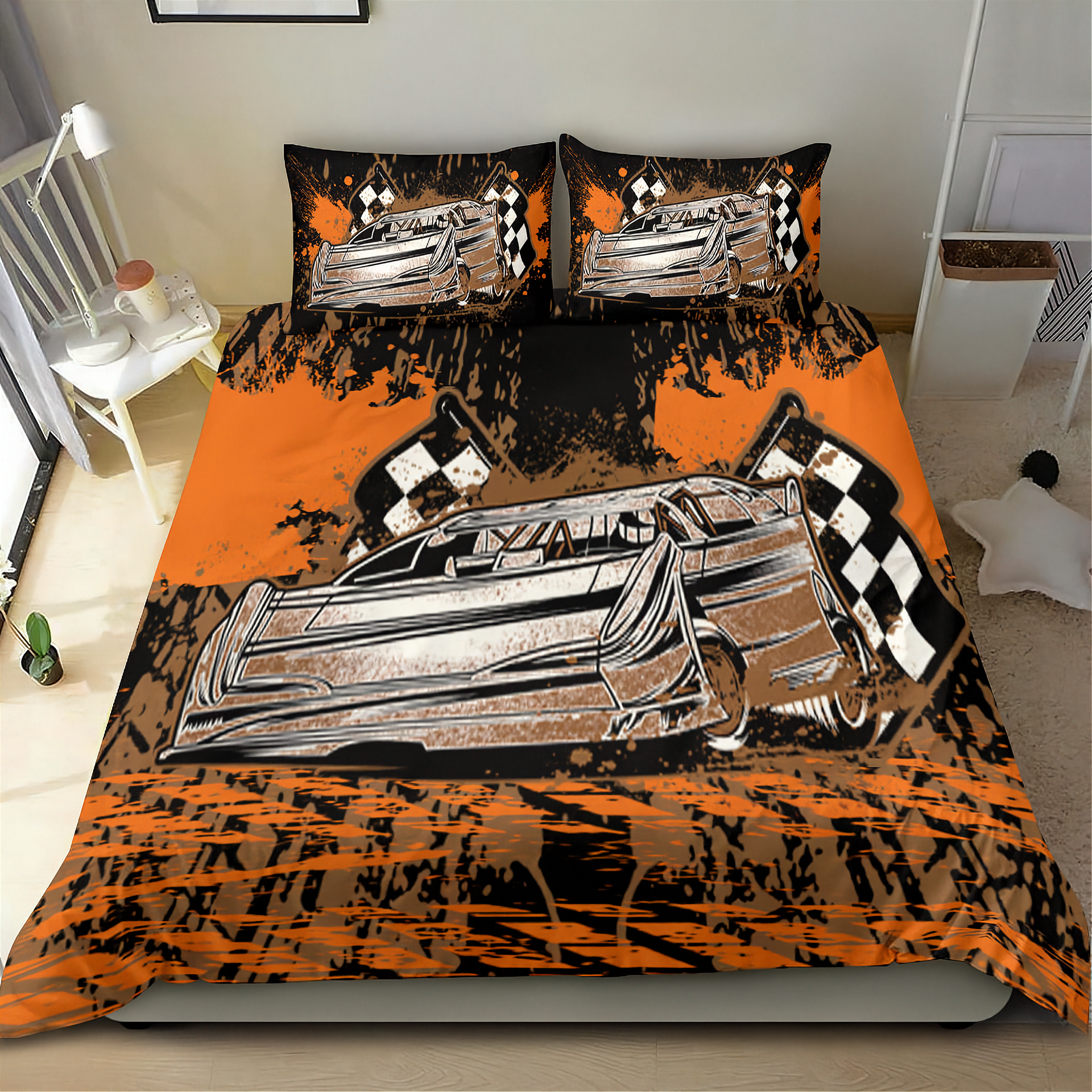 A racing-themed bedding set featuring a duvet cover and two matching pillowcases with a stylized silver race car, orange and black paint splatters, and checkered flags, shown on a bed in a bedroom setting.