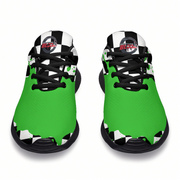 A pair of low-top athletic sneakers shown from the front on a white background. The shoes feature a bright green upper with a black and white jagged graphic pattern at the collar and around the sole, black laces, and a circular red and white 'Blades' logo on the tongue.