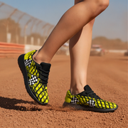 Person wearing black and yellow checkered running shoes on a track