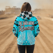 A woman standing on a dirt track wearing a bright turquoise hooded sweatshirt with black splatter graphics, a black-and-white checkered hood, and large 'DIRT TRACK RACING Racing' text across the back. The background shows a blurred dusty racetrack scene.