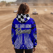 A person viewed from behind wearing a bright blue hooded sweatshirt with a black-and-white checkered hood and large 'DIRT TRACK RACING Racing' text and tire-track graphics on the back, standing on a dirt racetrack with cars blurred in the background.