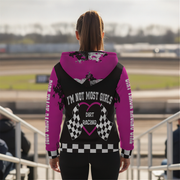 Woman wearing a pink and black hoodie with 'I'm Not Most Girls Dirt Racing' text at a race track.