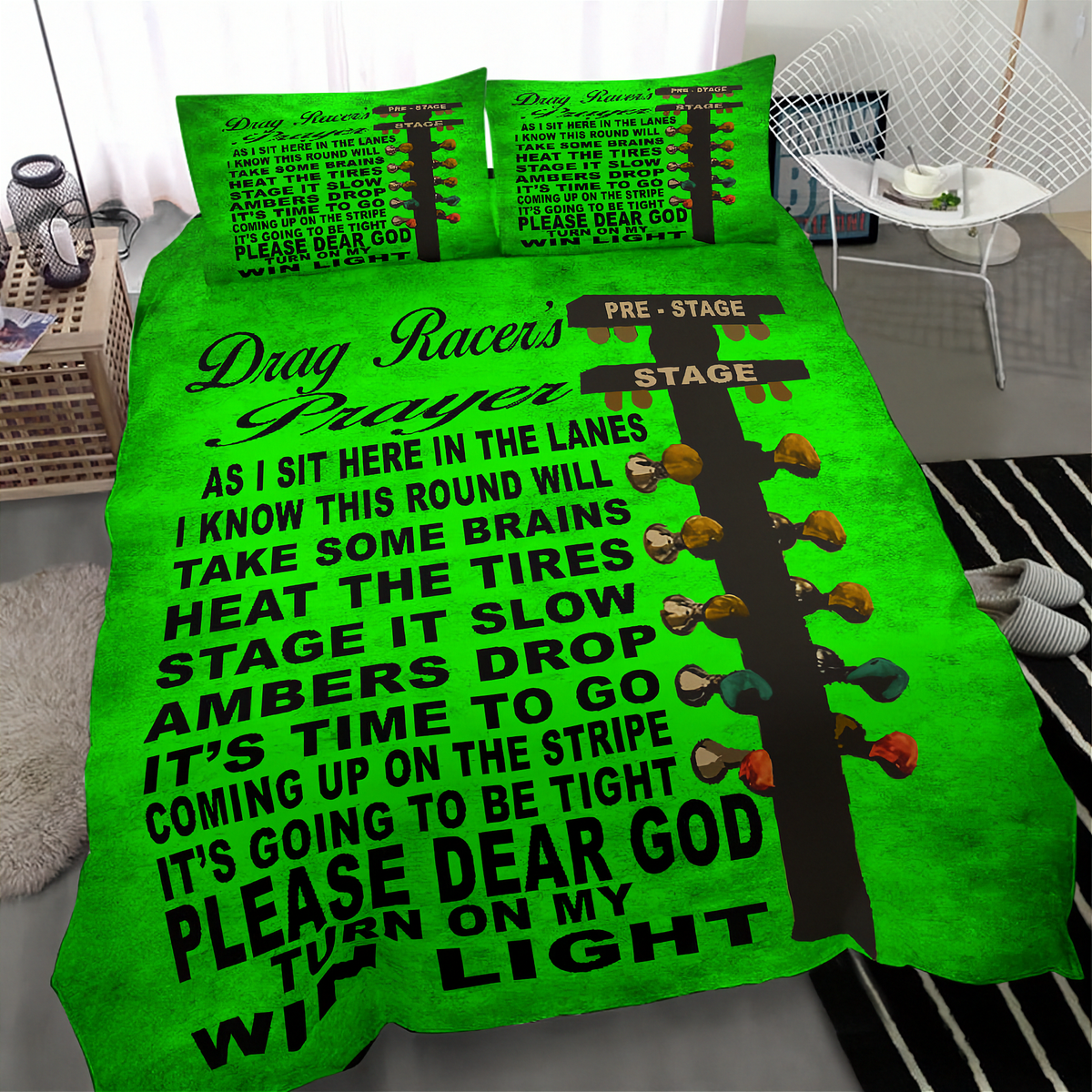 A bright green bedding set with a black and white drag racer prayer text design and multicolored bow tie graphics, shown on a bed in a modern bedroom setting.