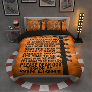 A racing-themed bedding set featuring a duvet cover and two matching pillowcases with a bold orange and black design, displayed on a bed in a styled bedroom setting.