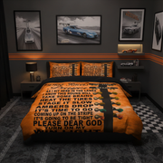A racing-themed bedding set displayed on a bed in a dark, modern bedroom. The set includes an orange and black comforter with bold black text and a black racing stripe, and two matching orange pillowcases.
