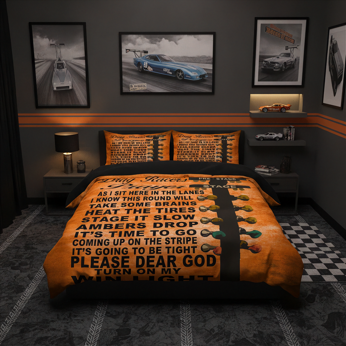A racing-themed bedding set displayed on a bed in a dark, modern bedroom. The set includes an orange and black comforter with bold black text and a black racing stripe, and two matching orange pillowcases.
