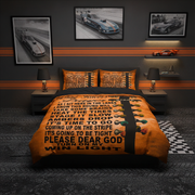 A bed dressed in an orange and black racing-themed bedding set with a large printed motivational quote and a striped light bulb graphic, shown in a styled bedroom with racing wall art, bedside lamps, and a small car model.
