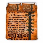 An orange bedding set featuring a duvet cover and two matching pillowcases with a printed Drag Racers Prayer design. The design includes black text and a black-and-orange guitar headstock graphic with colored tuning keys.