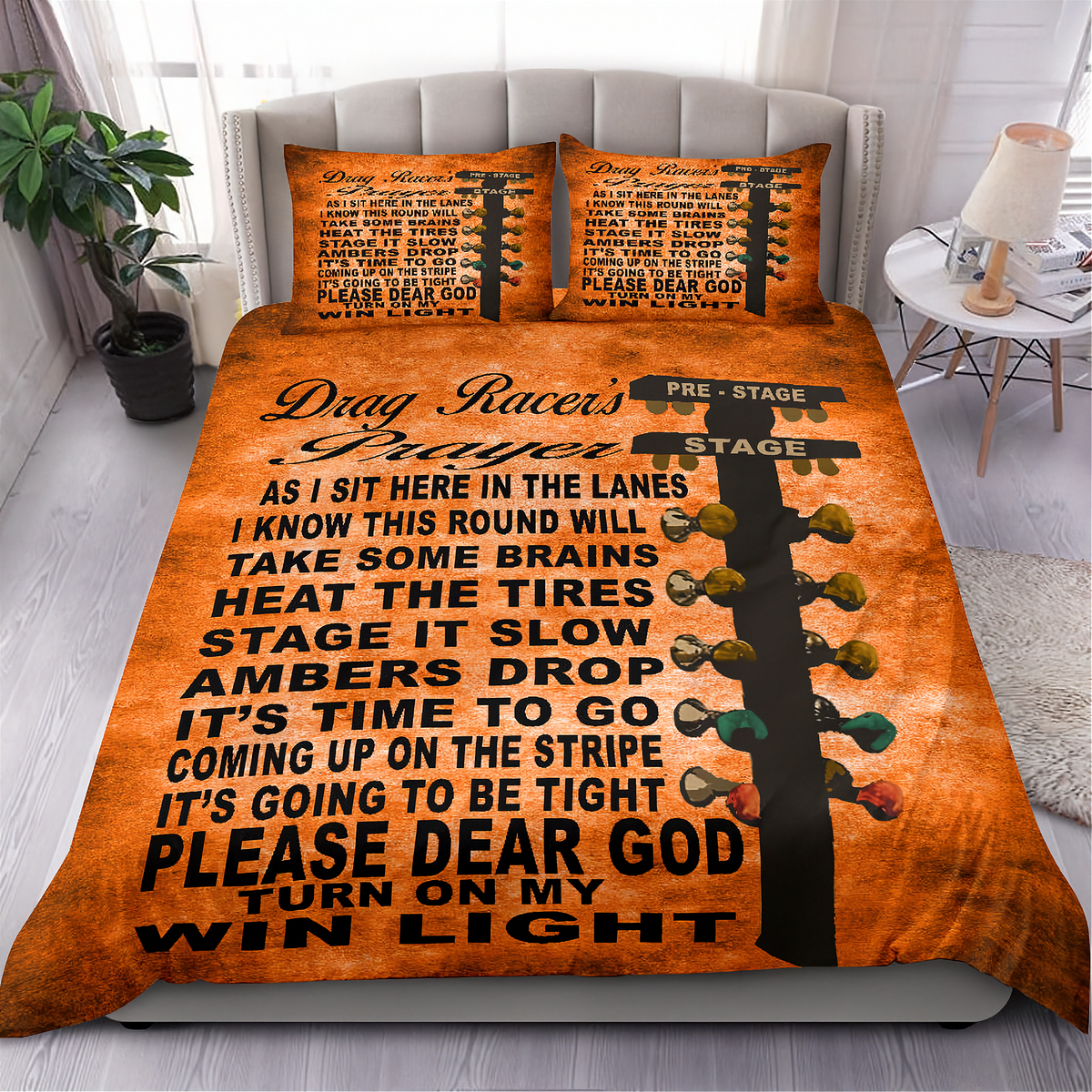 An orange drag racer themed bedding set featuring a printed graphic of a guitar headstock and a running text quote about drag racing, displayed on a bed in a styled bedroom setting.