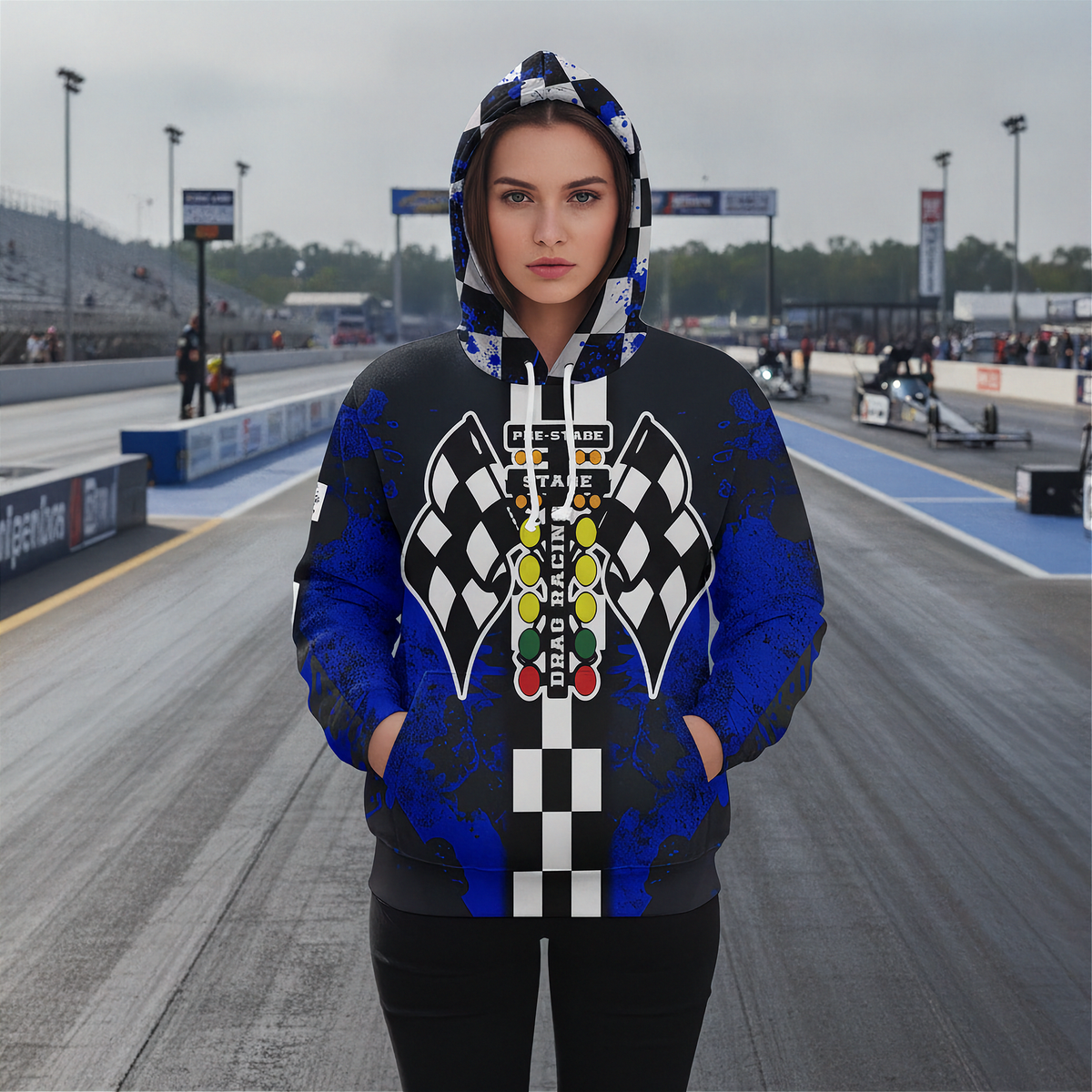 A woman wearing hooded sweatshirt shown from the front, featuring a drag racing-themed graphic with black and white checkered flags, a vertical checkered stripe, and a multi-colored race light sequence on a blue and black distressed background.