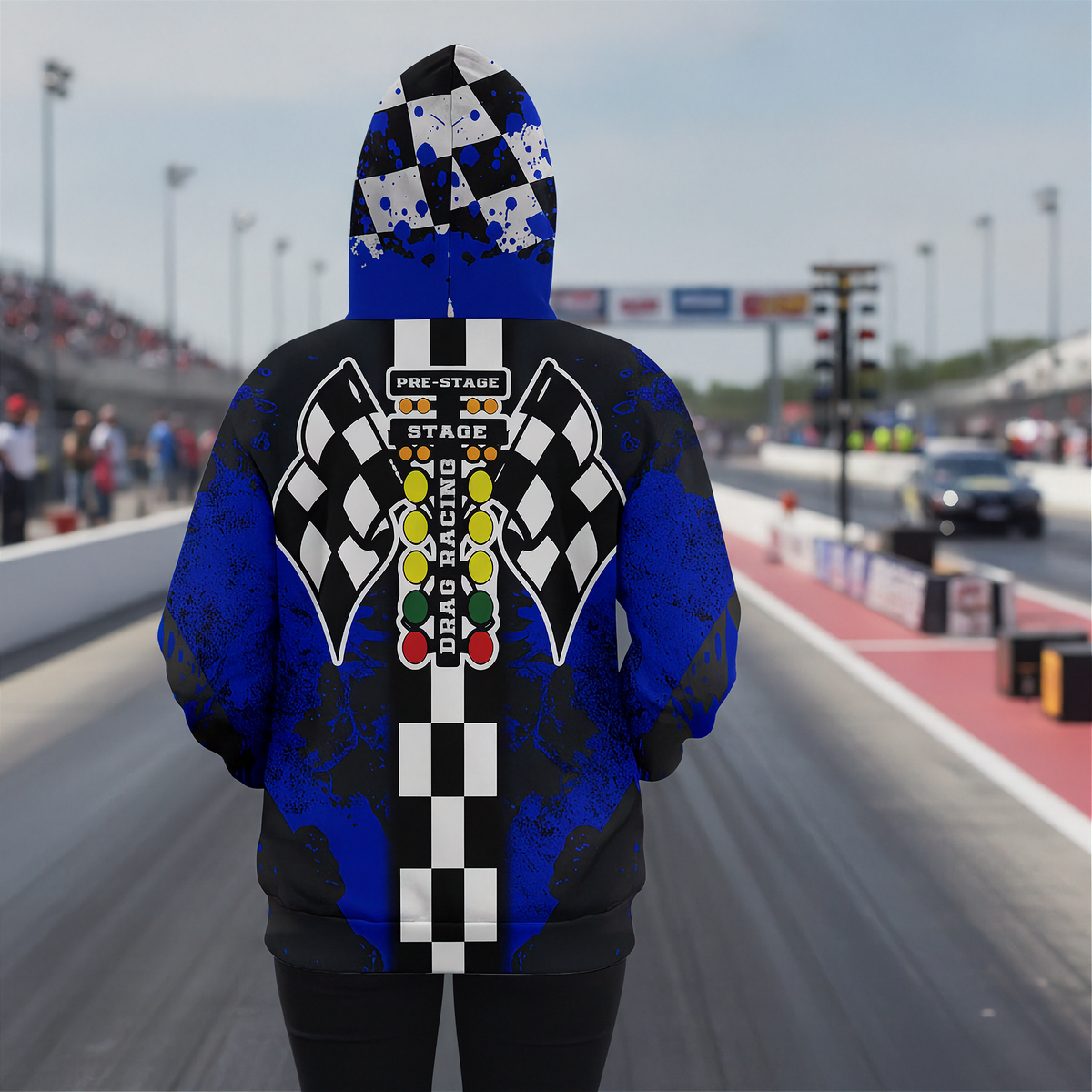 A woman wearing hooded sweatshirt shown from the back, featuring a drag racing-themed graphic with black and white checkered flags, a vertical checkered stripe, and a multi-colored race light sequence on a blue and black distressed background.