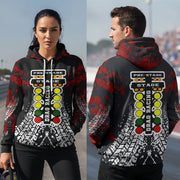 A man and woman standing on a racetrack wearing a black hoodie with a red hood and a large drag racing graphic on the back and front, featuring a light bar, racing lights, and tire tracks.