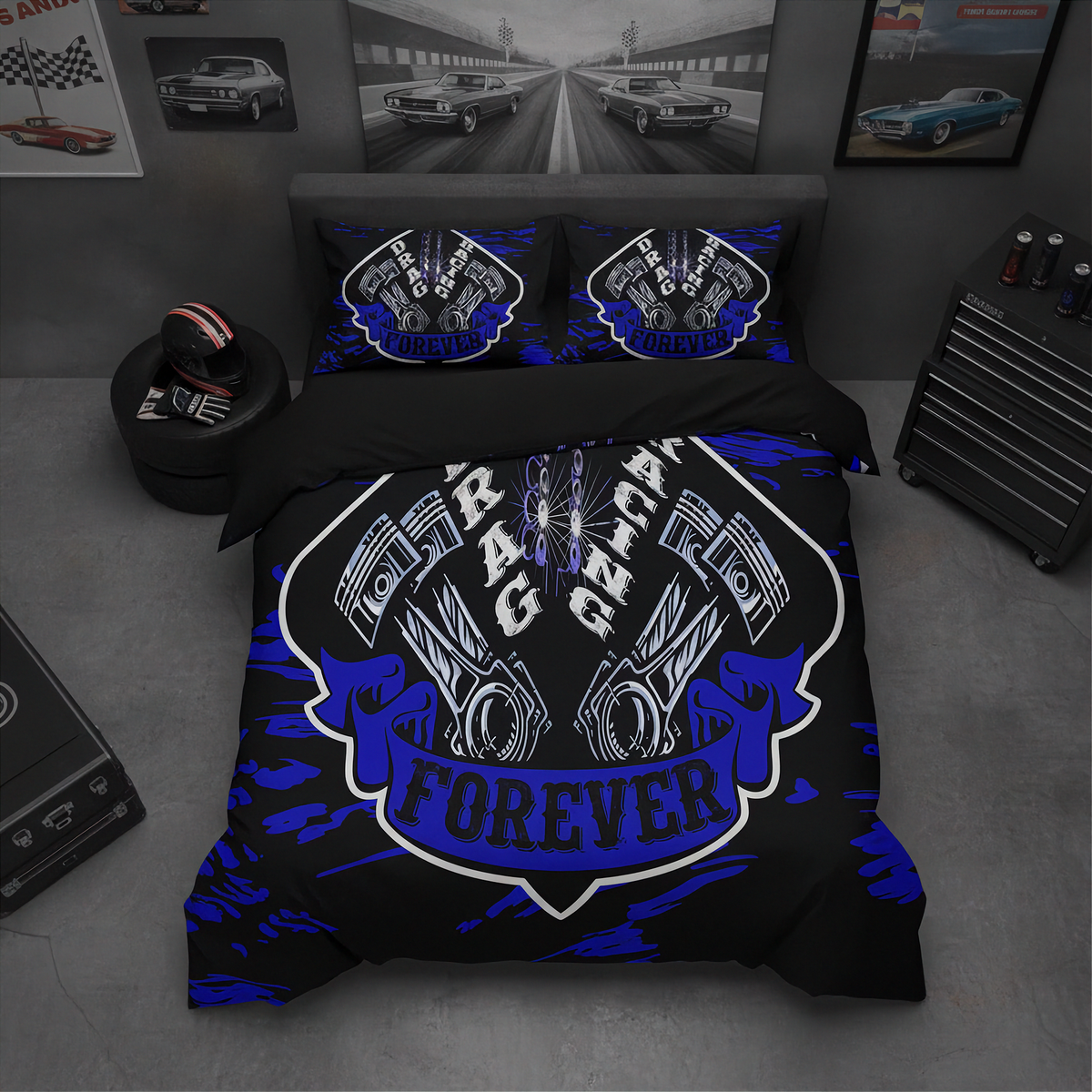A black bedding set with a bold blue and white racing graphic on the duvet cover and matching pillowcases, styled in a dark gray bedroom setting with car posters and a tool chest.