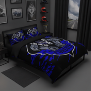 A bed dressed in a black and blue racing-themed bedding set with a large Harley-Davidson graphic, shown in a dark modern bedroom setting.