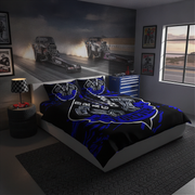 A racing-themed bedding set with a black duvet cover and matching pillowcases featuring blue and white graphics, styled in a dark gray bedroom with a drag racing wall mural and racing frames.
