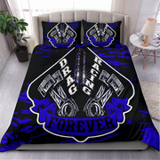 A bed dressed in a black bedding set with a bold blue and white 'Drag Racing Forever' graphic featuring pistons and chains, shown in a styled bedroom setting.