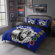 A blue and black bedding set with a tire and spark plug graphic, styled on a bed in a modern gray garage-themed bedroom.