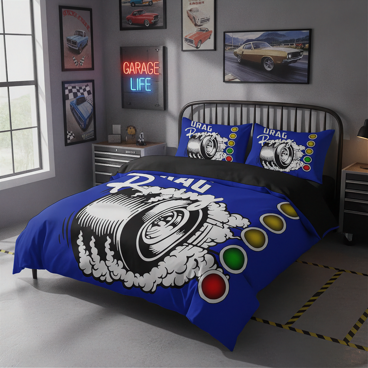 A blue and black bedding set with a tire and spark plug graphic, styled on a bed in a modern gray garage-themed bedroom.