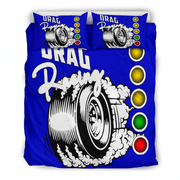 A blue bedding set including a duvet cover and two pillowcases with a drag racing graphic design. The design features a black and white tire with smoke, the words 'DRAG Racing', and a vertical row of yellow, gold, green, and red lights inspired by a traffic light.
