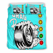 A bedding set featuring a turquoise duvet cover and two matching pillowcases with a graphic of a tire spinning up smoke and the words 'Drag Racing,' plus a vertical row of colored lights.