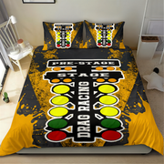 A racing-themed bedding set featuring a duvet cover and two pillowcases with a drag racing start-line graphic in black, yellow, white, green, and red, shown on a bed in a bedroom setting.