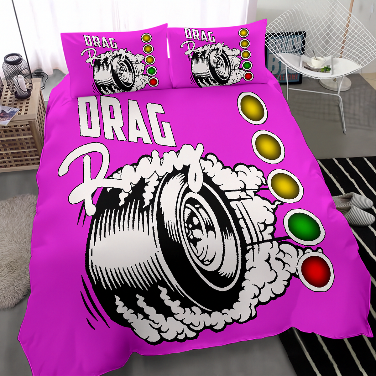 A bright pink bedding set featuring a drag racing graphic with a tire, smoke, and traffic light symbols, shown on a bed in a bedroom setting.