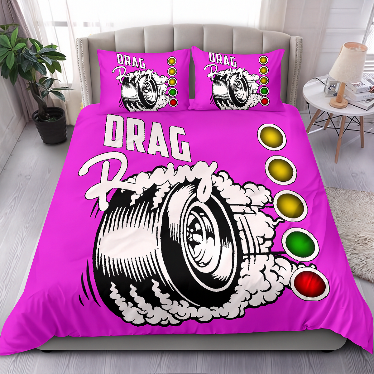 A bright pink bedding set featuring a duvet cover and two matching pillowcases with a drag racing graphic design. The design includes a black and white tire illustration with white smoke, the words 'DRAG Racing', and a vertical sequence of yellow, green, and red oval lights.
