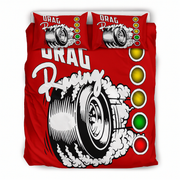 A red bedding set featuring a duvet cover and two matching pillowcases with a graphic design of a tire spinning on smoke, the words 'DRAG Racing', and vertical traffic light symbols in yellow, green, and red.