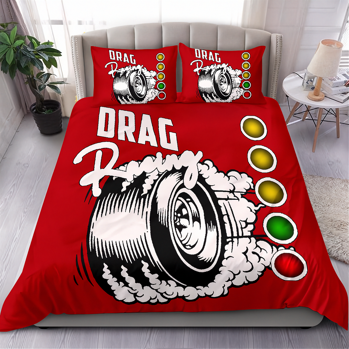 A red bedding set with a bold drag racing graphic, featuring a large tire illustration with smoke and the words 'DRAG Racing' on the duvet cover, with two matching pillowcases in a styled bedroom setting.