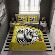 A yellow racing-themed bedding set with a large tire graphic and speedometer print, styled on a bed in a modern bedroom with black-and-white striped flooring and dark checkered walls.