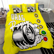 Bright yellow bedding set with a drag racing graphic, including a duvet cover and two matching pillowcases, styled in a modern bedroom setting.