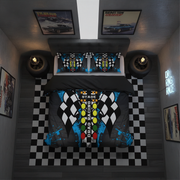 A racing-themed bedding set displayed on a bed in a styled bedroom. The set includes a duvet cover and two matching pillowcases featuring a black and white checkered flag pattern with a colorful central road graphic and blue paint splatters.