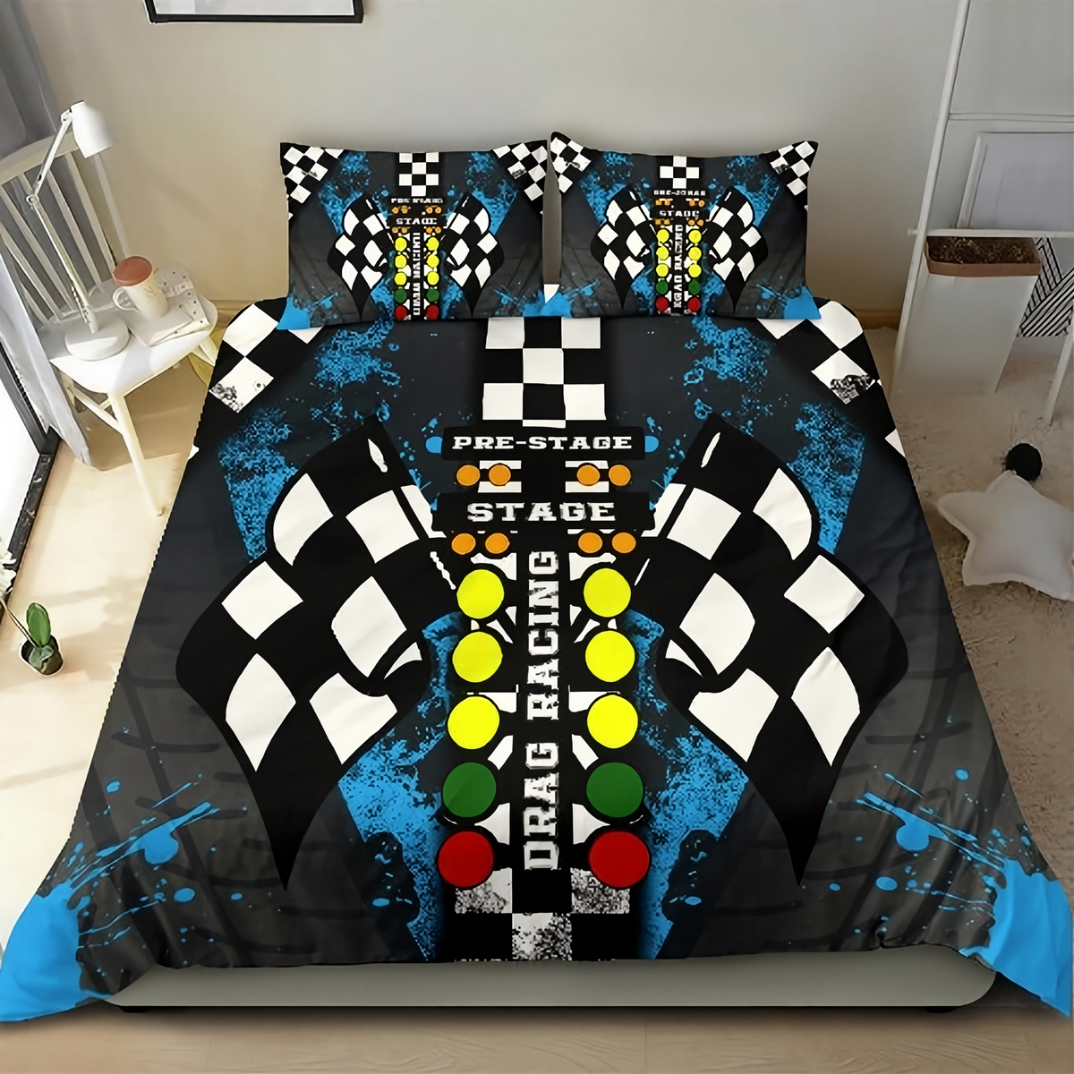 A racing-themed bedding set featuring a duvet cover and two matching pillowcases with a drag racing graphic design. The design includes black and white checkered flags, blue paint splatters, and a central control panel motif with yellow, green, and red buttons on a dark background, shown in a bedroom setting.