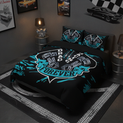 A bed dressed in a black bedding set with a bold racing graphic that reads 'DRAG RACING FOREVER' in white and bright teal, styled in a dark modern bedroom with car-themed wall art and bedside lamps.