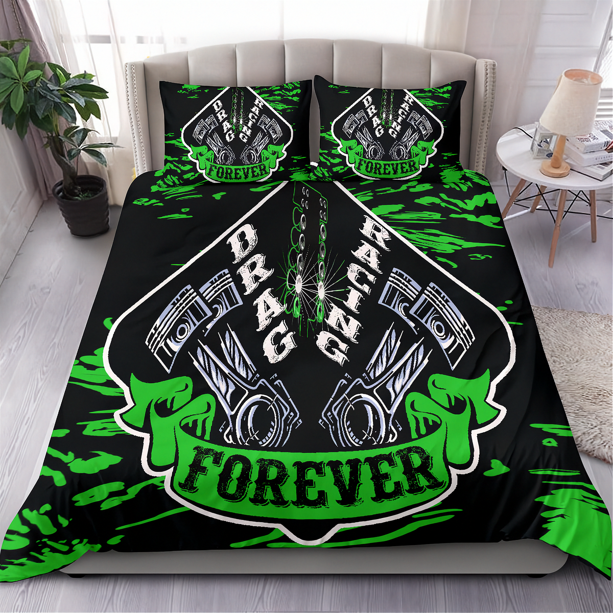 A bed dressed in a black bedding set with a bold green and white 'Drag Racing Forever' graphic print, styled in a modern bedroom setting with a side table, lamp, and plant.
