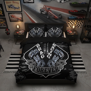 A racing-themed bedding set displayed on a bed in a styled bedroom. The set includes a black duvet cover and two matching pillowcases featuring a large white and gray 'Drag Racing Forever' shield graphic with engine parts and a chain.
