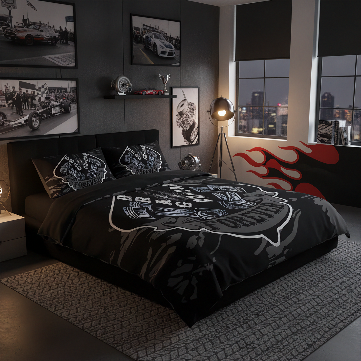 A black and gray racing-themed bedding set with a large helmet graphic and smaller matching pillowcases, styled in a dark modern bedroom with racing wall art, a floor lamp, and a city skyline at night visible through the windows.