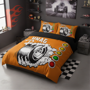 An orange and black racing-themed bedding set with a large tire graphic and red, yellow, and green light bulbs, shown on a bed in a styled gray bedroom.