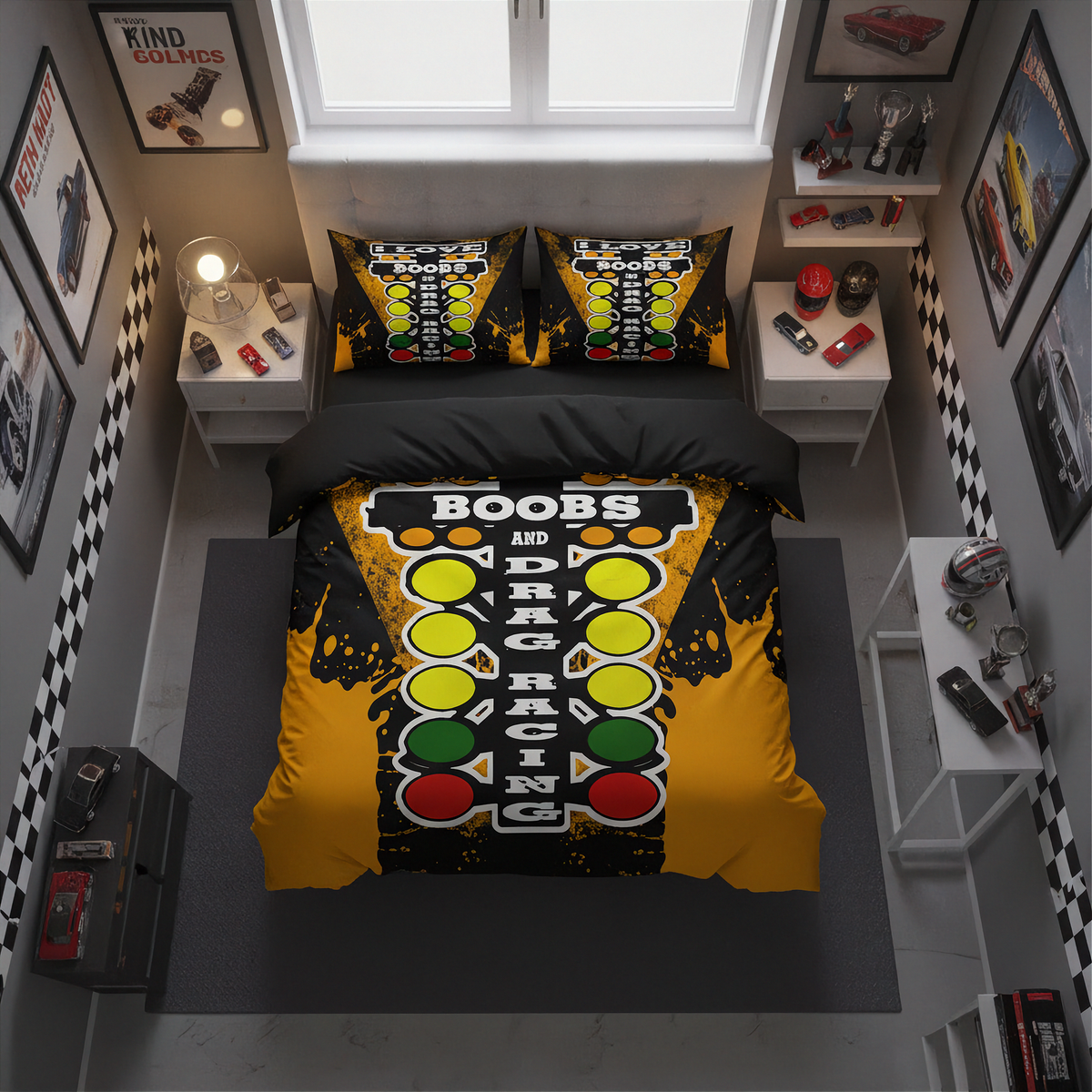 A top-down view of a bed dressed in a novelty racing-themed bedding set, featuring a yellow and black graphic with red, yellow, and green elements and the words 'BOOBS AND DRAG RACING'. The room has a gray floor, white walls, and racing-themed framed posters and decor.