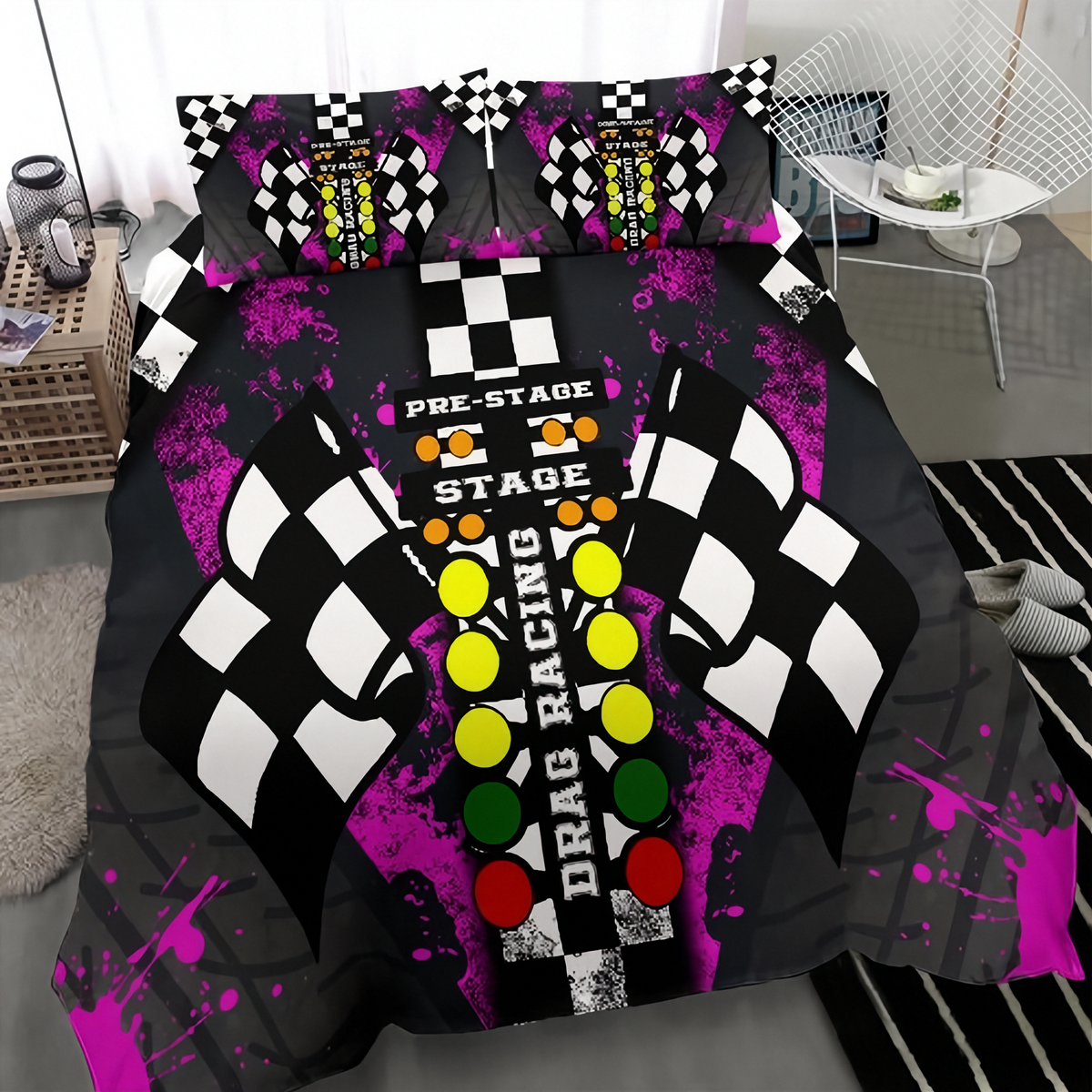 A bedding set featuring a drag racing theme, displayed on a bed in a bedroom setting. The set includes a duvet cover and two matching pillowcases with a black and white checkered pattern, purple paint splatters, and colorful race button graphics (yellow, green, red, orange) on a gray background.