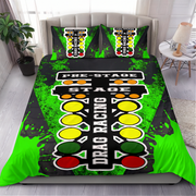 A bedding set featuring a racing track and traffic light theme, displayed on a bed in a modern bedroom setting. The set includes a duvet cover and two matching pillowcases with a black, green, yellow, and red design depicting a race start line and traffic signals.
