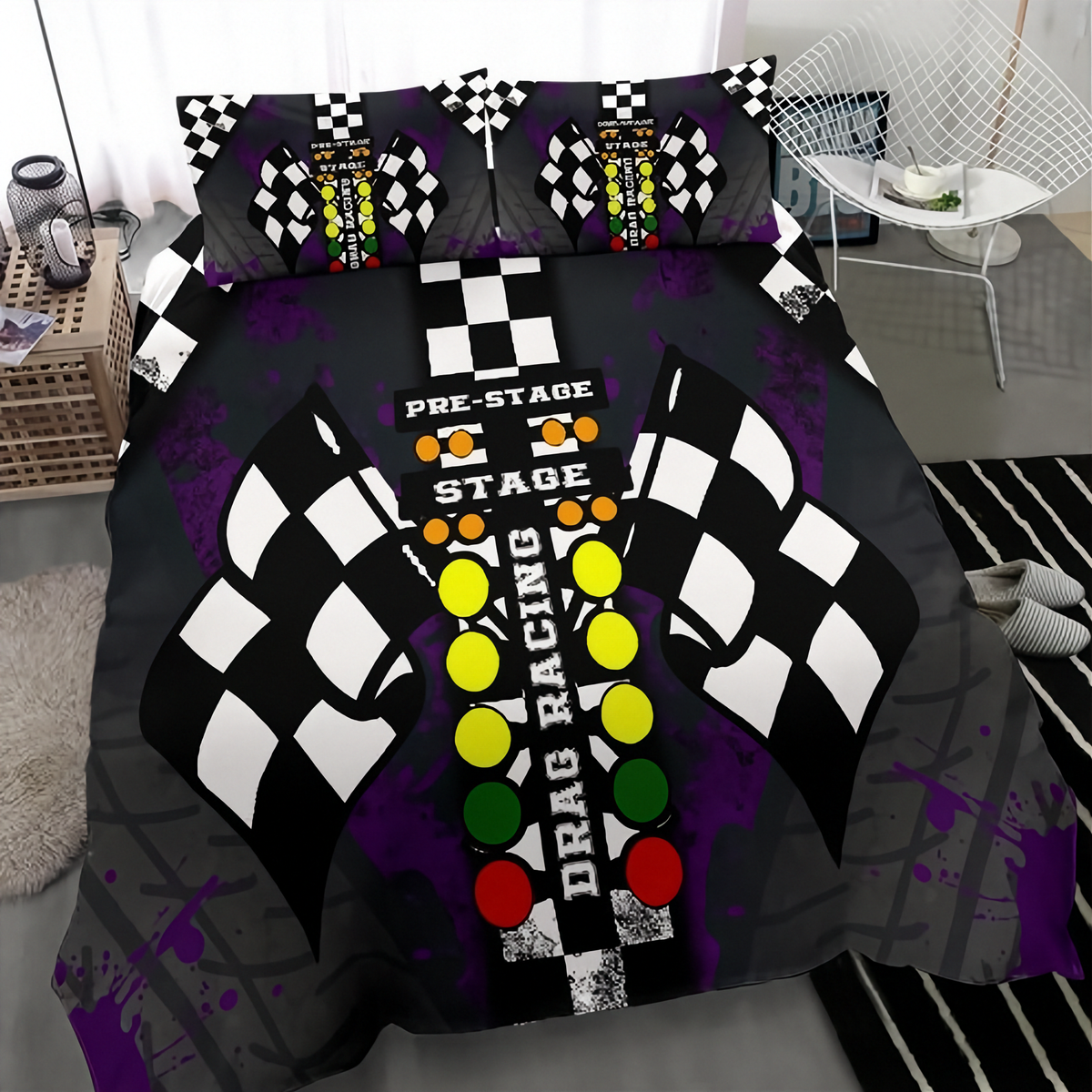 A bedding set featuring a duvet cover and two pillowcases with a drag racing theme, displayed on a bed in a modern bedroom setting. The design includes a black and white checkered flag motif, the words 'PRE-STAGE', 'STAGE', and 'DRAG RACING', and a vertical sequence of yellow, green, and red lights on a black background with purple paint splatters.