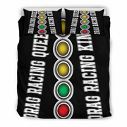 A black bedding set, including a duvet cover and two pillowcases, featuring a drag racing theme with the words 'DRAG RACING QUEEN' and 'DRAG RACING KING' in white text alongside a vertical sequence of yellow, gold, green, and red oval lights on a white background.