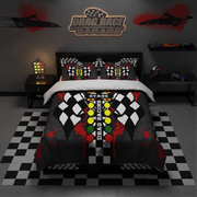 A racing-themed bedding set displayed on a bed in a styled bedroom. The comforter and matching pillow shams feature a black and white checkered flag pattern with a central vertical column of red, yellow, and green race lights, plus 'DRAG RACE' and 'STAGE 1' text.