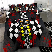 A racing-themed bedding set featuring a duvet cover and two matching pillowcases with a black and white checkered flag design, red paint splatters, and colorful race lights on a bed in a modern bedroom setting.